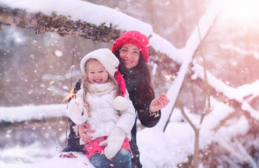 A winter fairy tale, a young mother and her daughter ride a sled