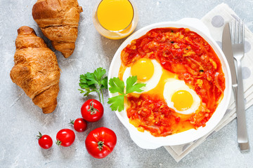 Tasty and Healthy Shakshuka in a Frying Pan. Eggs Poached in Spicy Tomato Pepper Sauce. Top view