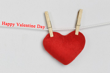 Red heart hanging on a rope and have Happy valentine day text.