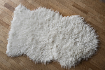 white wool rug on wooden floor