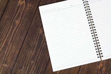 Notebook or empty white paper on wood table top view with copy space,