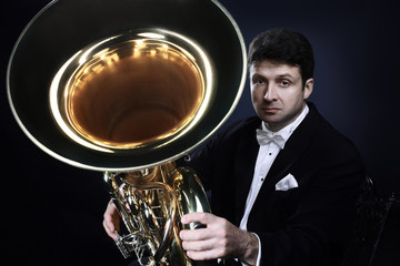 Fototapeta premium Tuba brass instrument. Classical musician portrait man horn player
