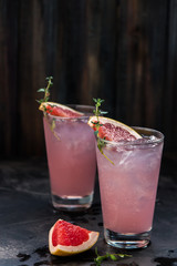 Homemade grapefruit lemonade with ice in glass