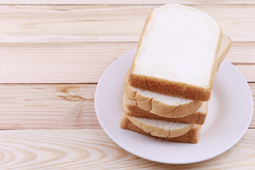 Sliced bread Stacked in dish on wooden floor.