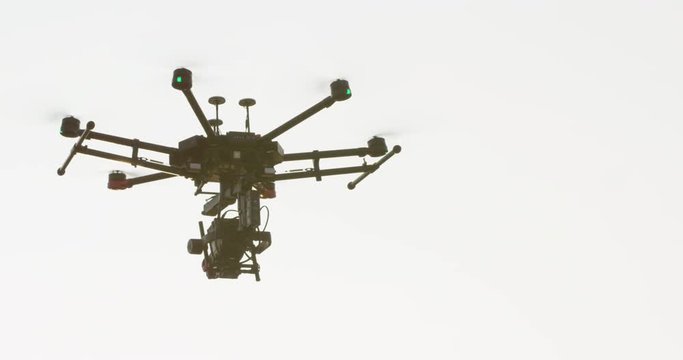 Large drone flying towards sunset - slow motion close up