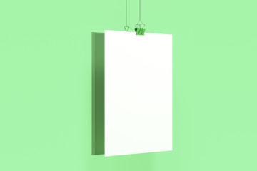 Blank white poster with binder clip mockup on green background