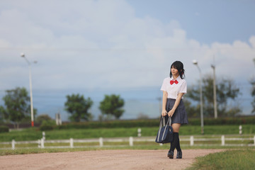 Obraz premium Japanese school in countryside with grass mountain and tree