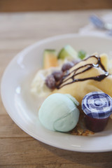 crepe cake with milk ice cream and watermelon melon grapes on wood background