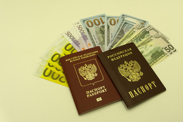 Fototapeta premium Russian European passport provides a different dollars , and three Euro banknotes on a white background.