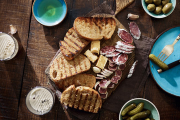 Italian snacks Bruschetta on wooden table with beer
