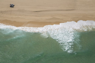 Naklejka na ściany i meble Coastal ocean beach from above