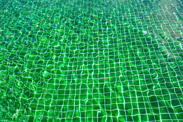 Water abstract background, Swimming pool rippled.Under water tile of swimming pool floor.
