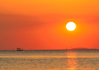 Fishing boat in the sea Having a sunset is the background