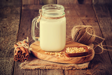 cedar milk in a glass jar and pine nuts