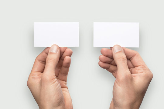Mockup business card back and front horizontal empty blank holds the man in his hand. Isolated on a gray background