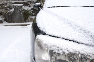 Snow-covered car headlights