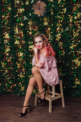 Portrait of the Beautiful woman posing on Christmas background.