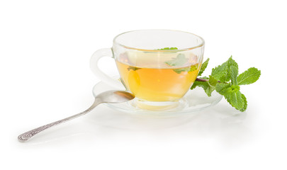 Tea with mint in glass cup on a white background