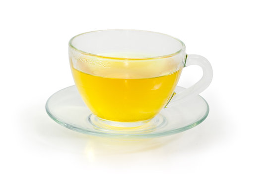 Green tea in glass cup on glass saucer