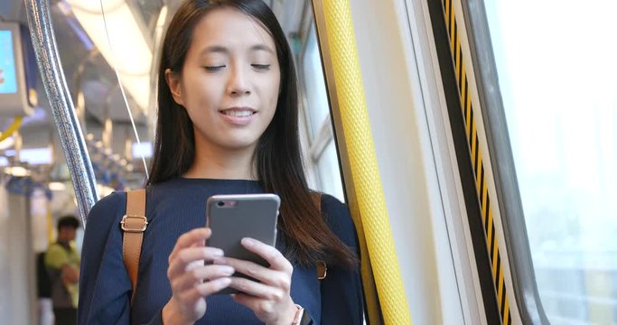 Woman use of mobile phone in train compartment