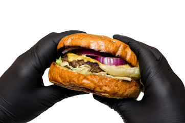 Homemade burger in hands on white background