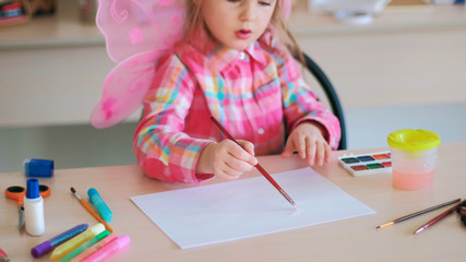 hardworking little cutie on art lessons. creative process. lifestyle of talented people.