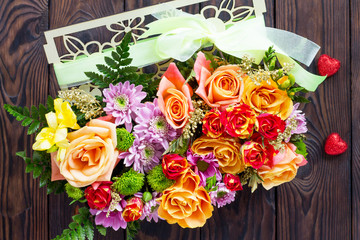 Background of Valentine's Day or wedding day. Beautiful bouquet of flowers as a gift on a wooden background. Top view.