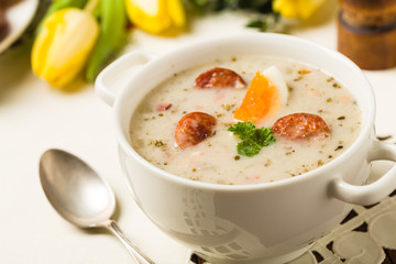 Traditional Polish white borsch with Easter decoration