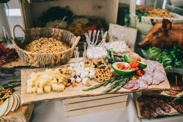 Meat, cheese and nutmeg wedding buffet with various snacks.