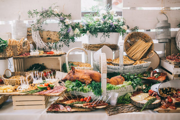 Meat, cheese and nutmeg wedding buffet with various snacks.