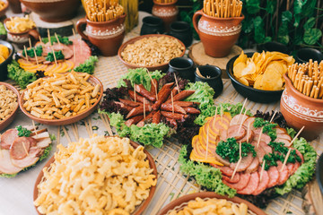 Meat, cheese and nutmeg wedding buffet with various snacks.