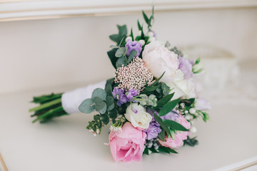 White shoes and a bridal bouquet for the wedding.