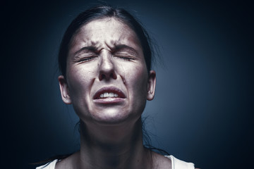 Obraz premium Close up portrait of a crying woman with bruised skin and black eyes