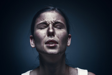 Obraz premium Close up portrait of a crying woman with bruised skin and black eyes