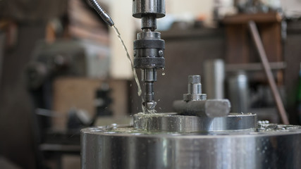 Industrial drill bit machine cooled with water to prevent overheating