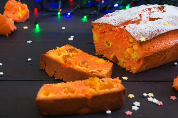 Cupcake with orange and dried apricots on Christmas background