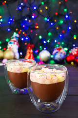 Cup of hot cocoa with marshmallows on Christmas background