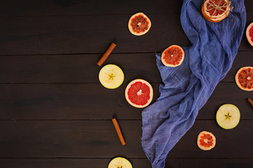 Apple, grapefruit and cinnamon on wooden background. Ingredient for hot mulled wine. Top view