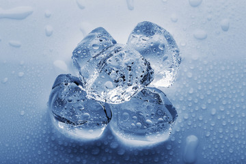 Frozen large ice cubes in the droplets of water