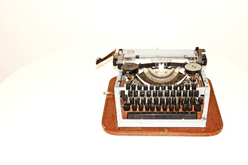 Old worn vintage typewriter on a light background