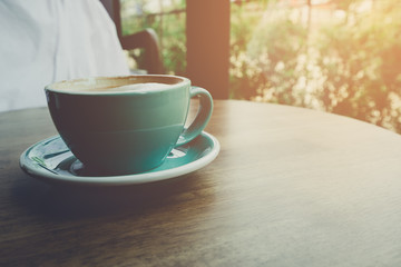 Coffee on the wood table and sunlight