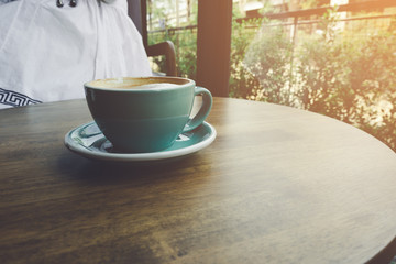 Coffee on the wood table and sunlight