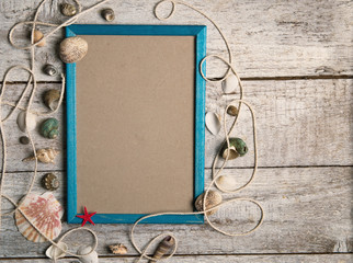  frame and sea shells on wood background