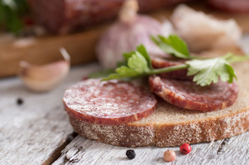 salami and bread on a wooden board