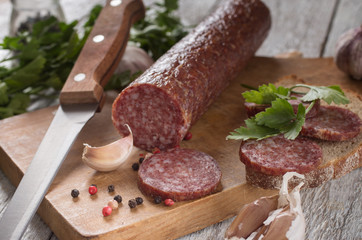 salami and bread on a wooden board