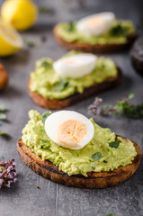Bio avocado on bread with boiled egg