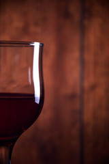  A glass of red wine on an old wooden rustic background