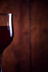  A glass of red wine on an old wooden rustic background