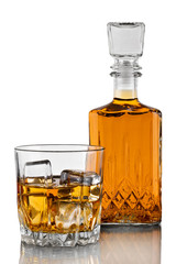 Glass of whiskey with ice and decanter on white background