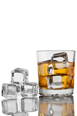 Glass of whiskey with ice and decanter on white background